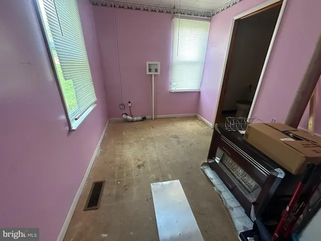 a view of a room with furniture and a window