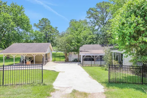 a front view of a house with a garden and plants