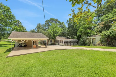 a view of a house with a backyard and a patio