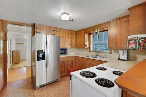 a kitchen with a refrigerator and a stove