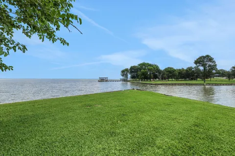 a view of a lake with a yard