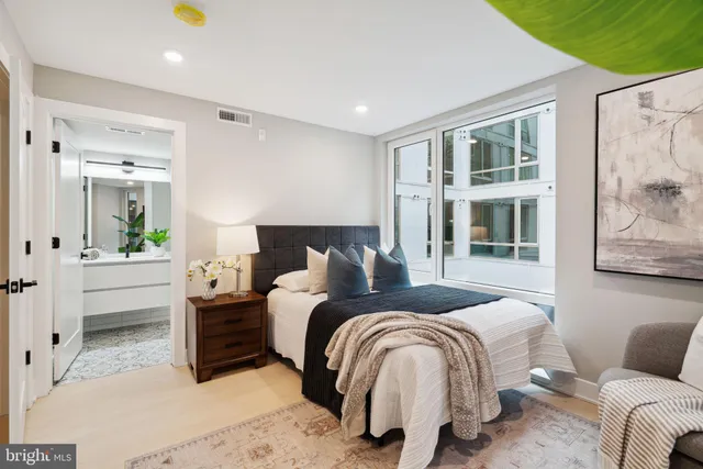a bedroom with bed and wooden floor