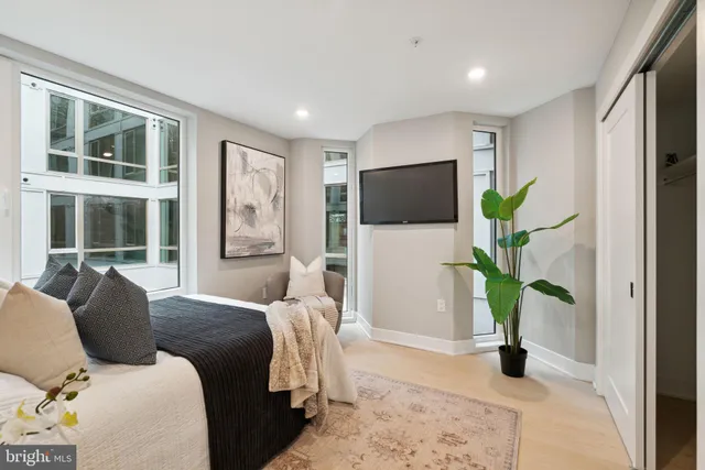 a bedroom with furniture and a potted plant