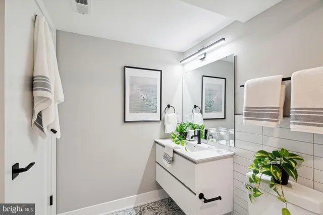 a bathroom with a sink mirror and vanity