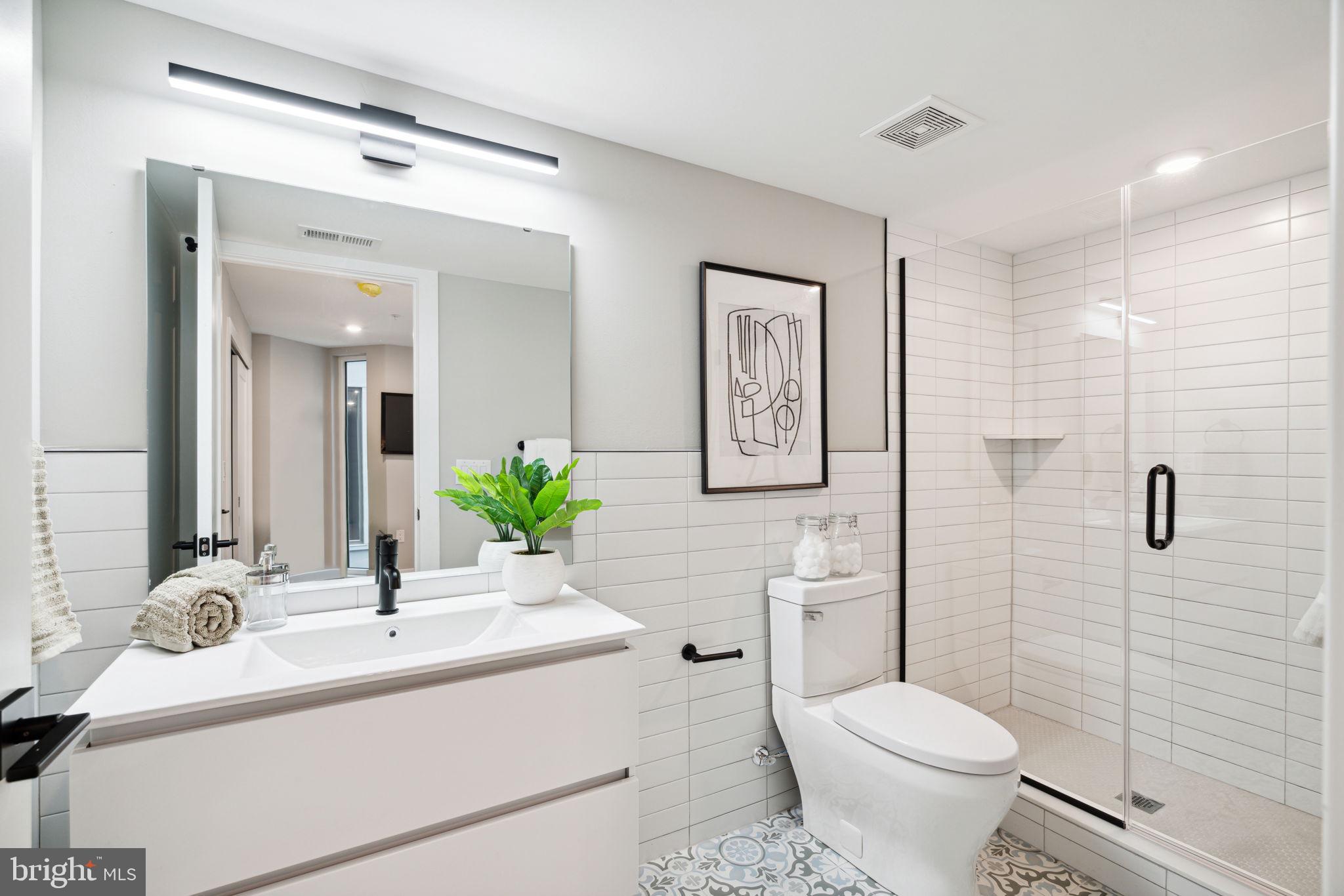6604 Ridge Avenue, Unit 311 Philadelphia, PA 19128 - Photo 19 of 32 a bathroom with a sink toilet and shower