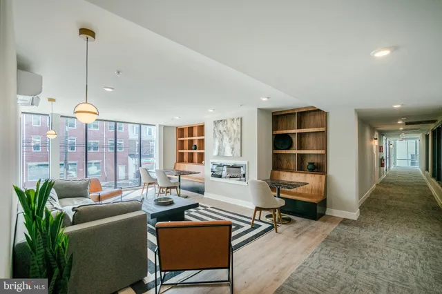 a living room with furniture window and wooden floor