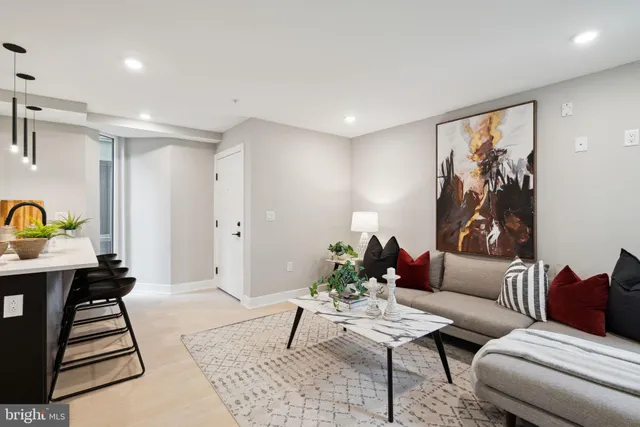 a living room with furniture and wooden floor
