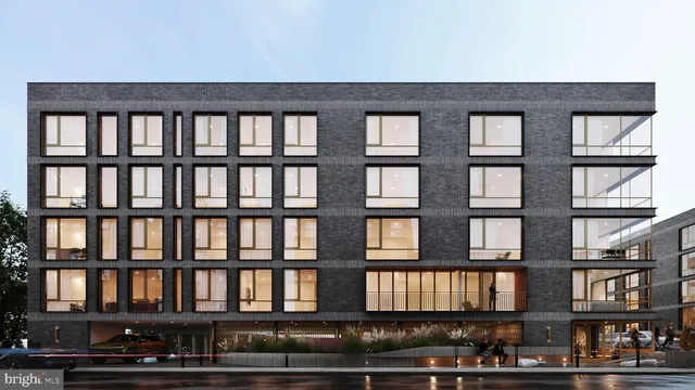 a view of a brick building next to a yard