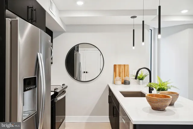 a dining table with a potted plant on a counter and a sink