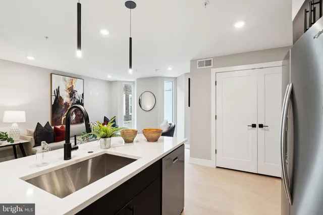 a kitchen with a refrigerator and a sink