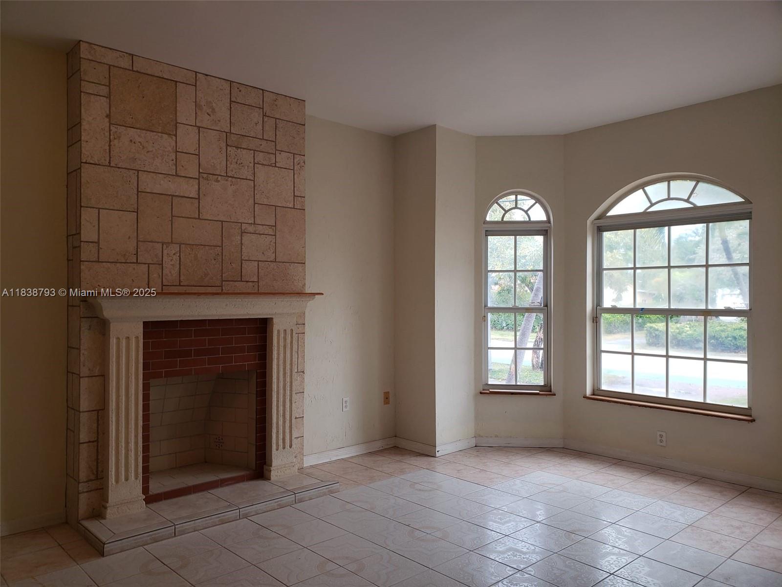 3124 Prairie Avenue Miami Beach, FL 33140 - Photo 14 of 36 an empty room with windows and fireplace