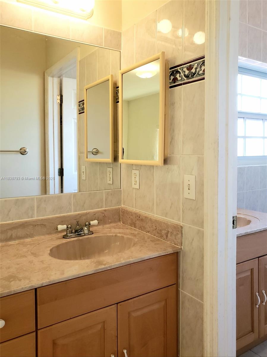3124 Prairie Avenue Miami Beach, FL 33140 - Photo 22 of 36 a bathroom with a sink and a mirror