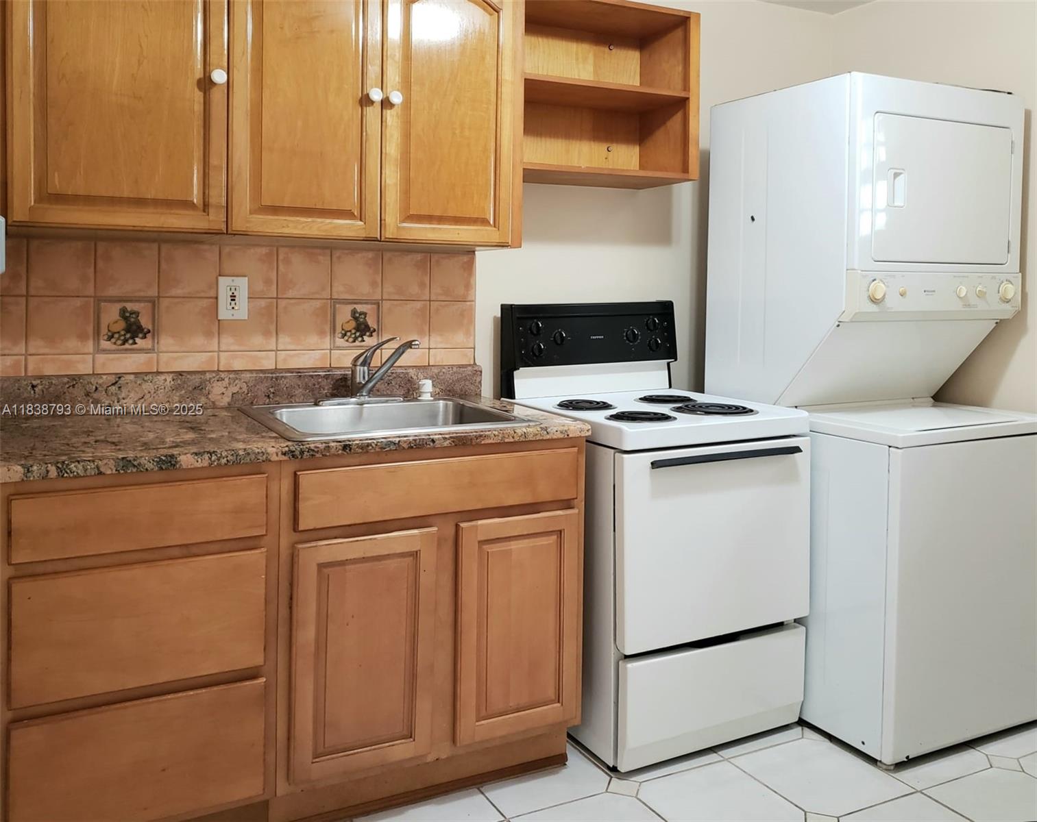 3124 Prairie Avenue Miami Beach, FL 33140 - Photo 24 of 36 a kitchen with stainless steel appliances granite countertop a sink stove and cabinets