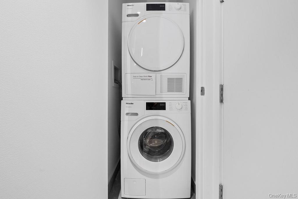 136-18 Maple Avenue, Unit 9A Queens, NY 11355 - Photo 21 of 35 Laundry area featuring stacked washing machine and dryer