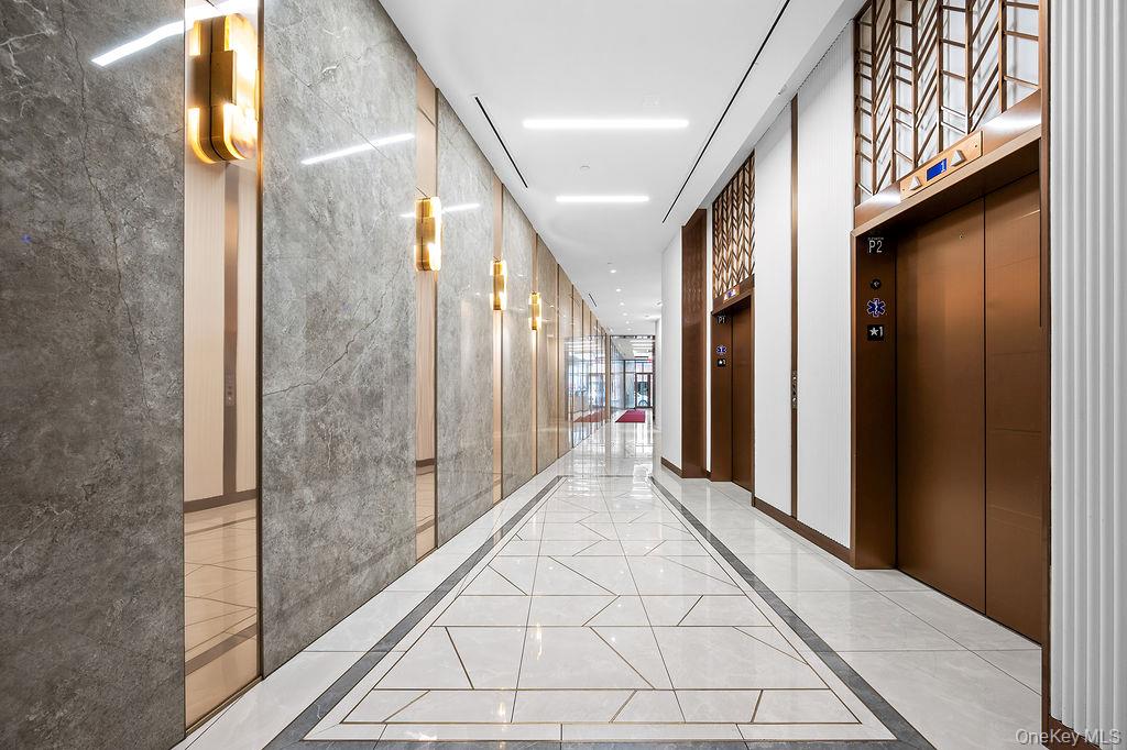 136-18 Maple Avenue, Unit 9A Queens, NY 11355 - Photo 25 of 35 Hall featuring elevator and inlaid floor details