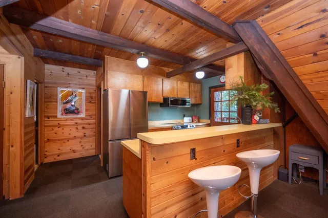 a kitchen with a wooden floor and a sink