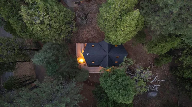 an aerial view of a house with a yard