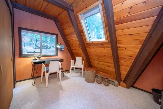 a view of a room with a table and chairs