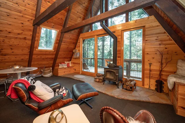 a view of a small house with a tree in the background
