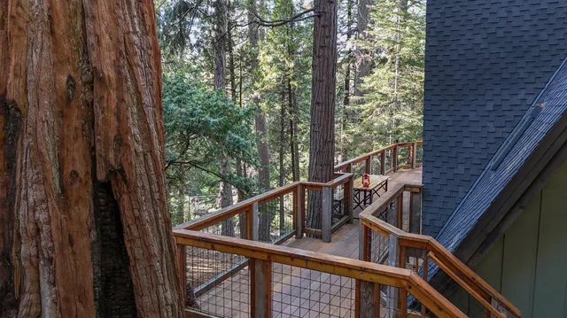 a view of balcony with wooden floor and fence