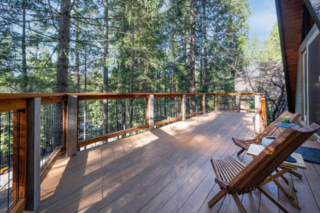 a view of balcony with wooden floor and seating space