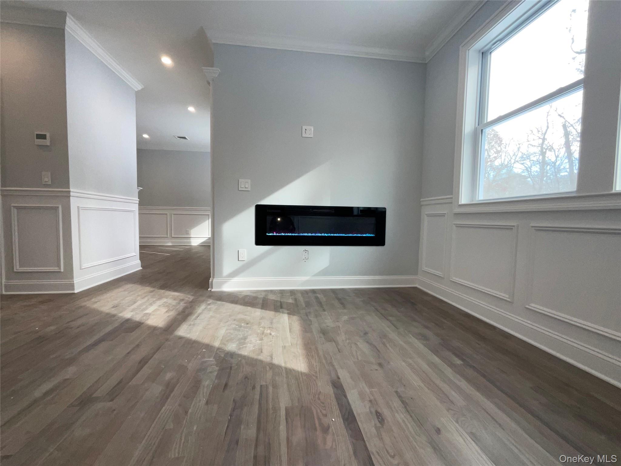 89 B Mount Sinai-Coram Road Coram, NY 11727 - Photo 12 of 23 wooden floor in an empty room with a window