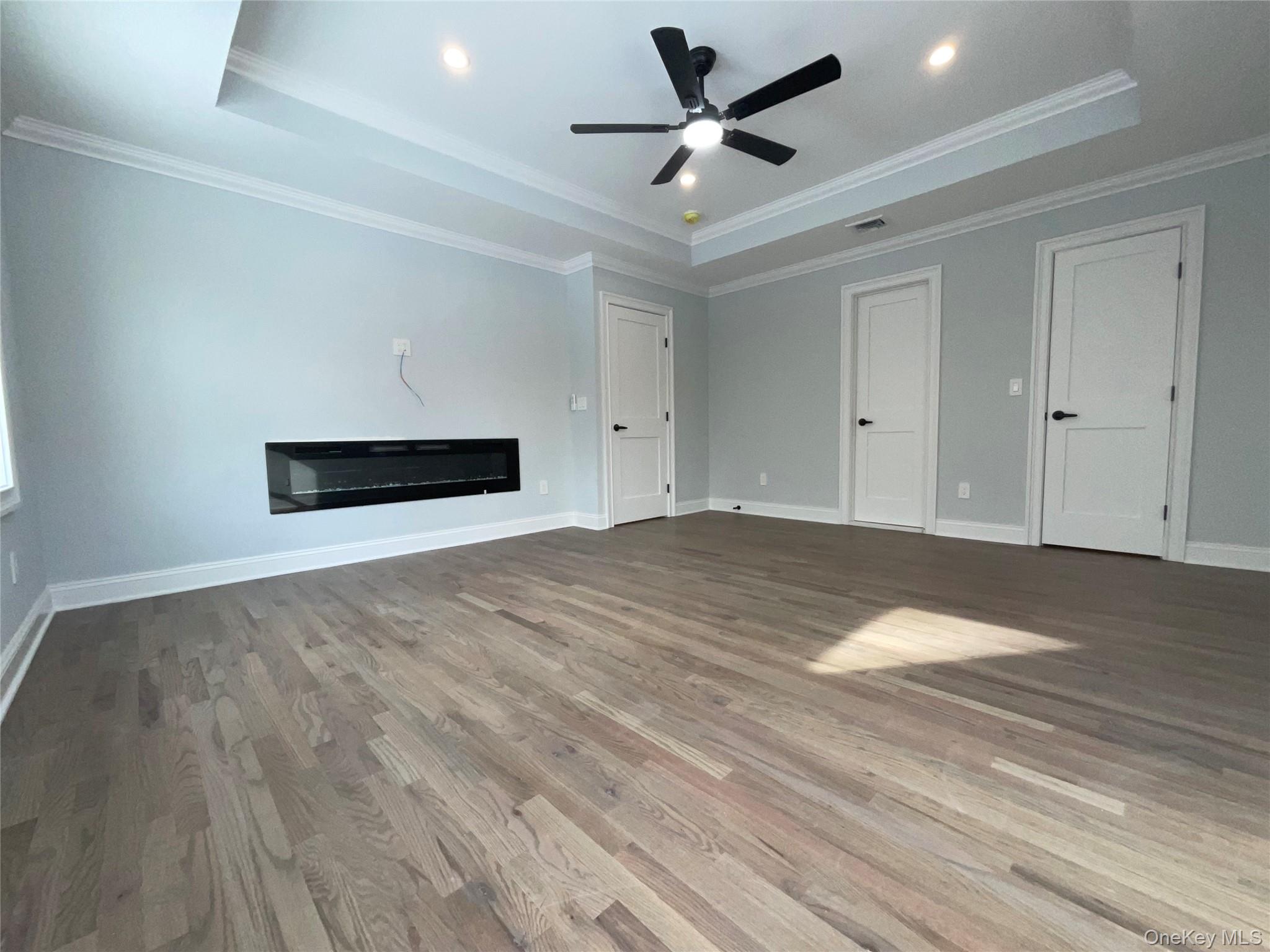 89 B Mount Sinai-Coram Road Coram, NY 11727 - Photo 15 of 23 a view of empty room with wooden floor and fan