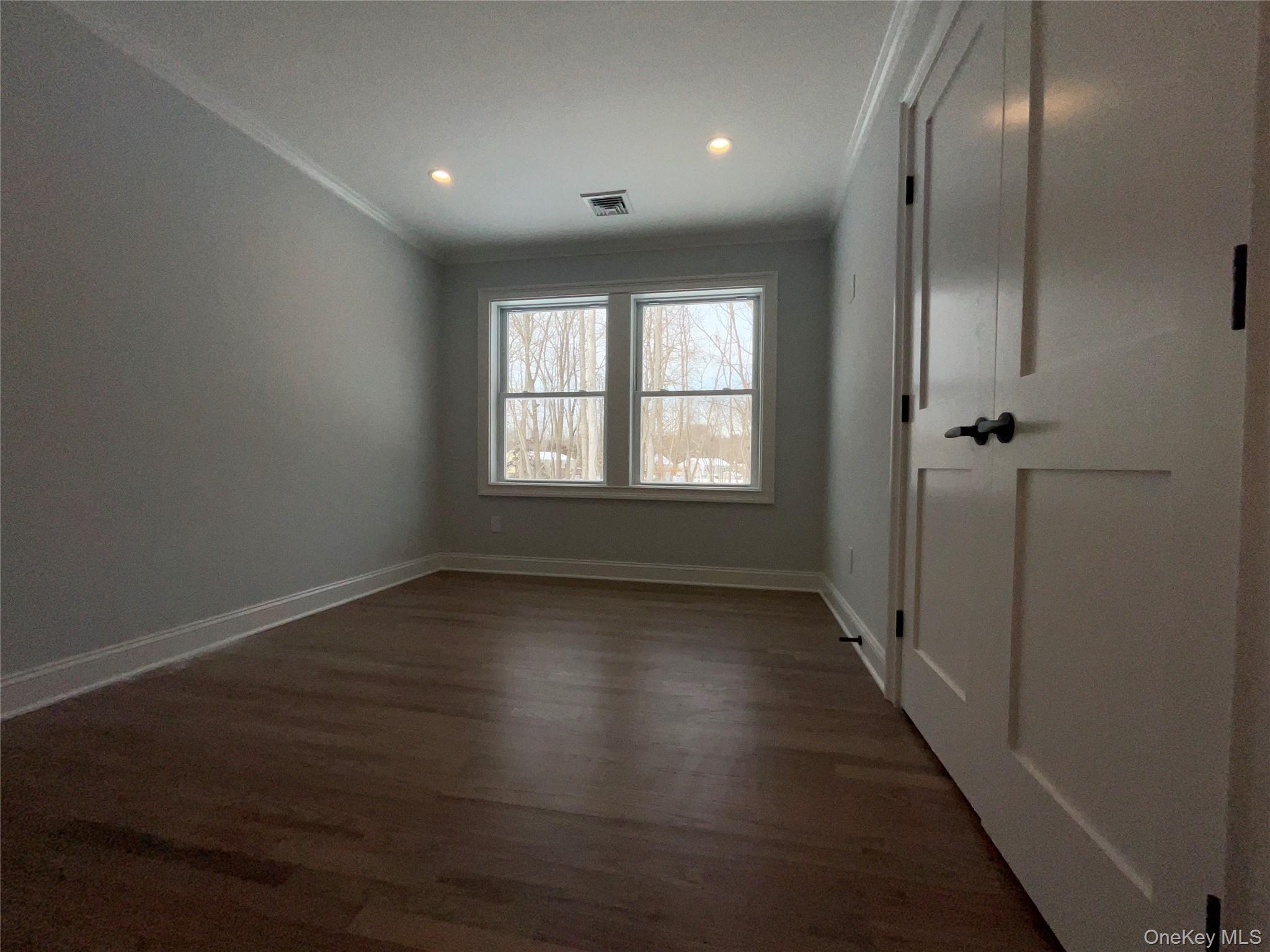 89 B Mount Sinai-Coram Road Coram, NY 11727 - Photo 21 of 23 an empty room with wooden floor and windows