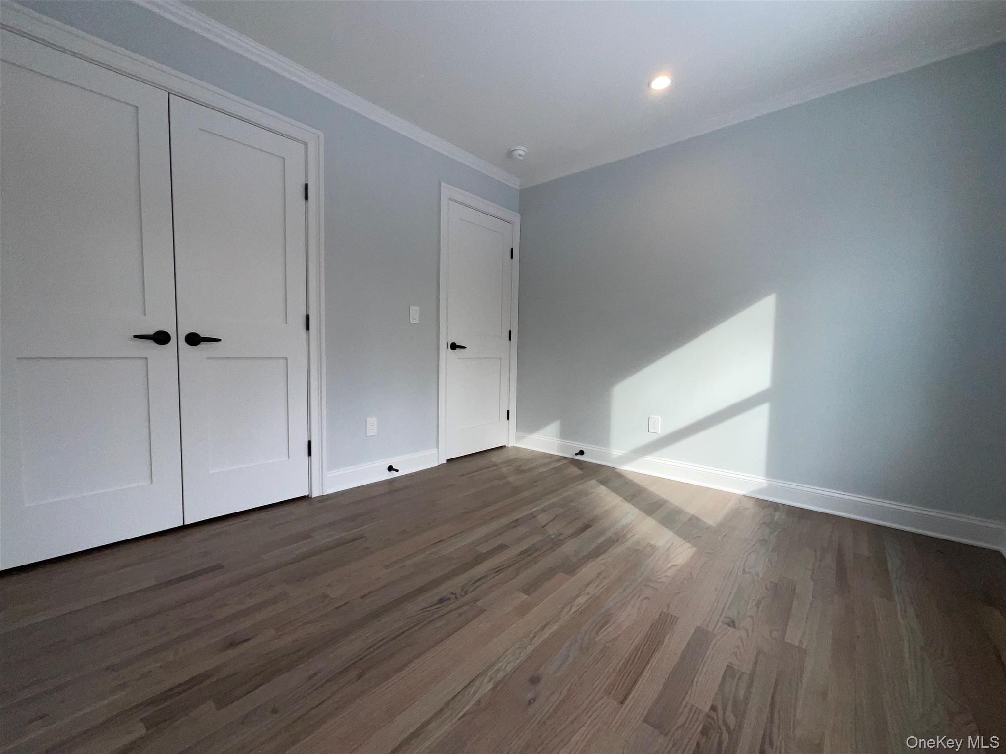 89 B Mount Sinai-Coram Road Coram, NY 11727 - Photo 23 of 23 a view of an empty room with wooden floor