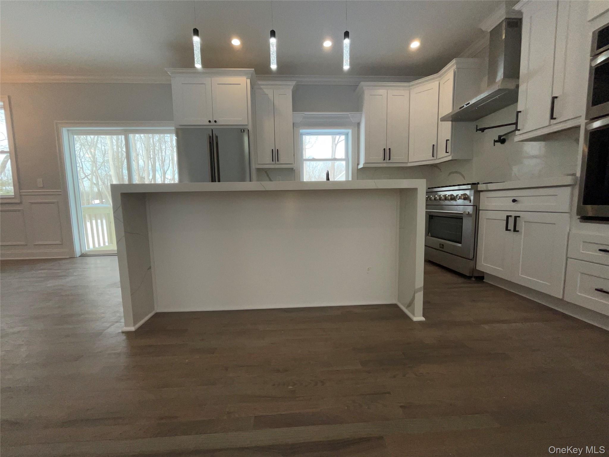 89 B Mount Sinai-Coram Road Coram, NY 11727 - Photo 7 of 23 a kitchen with stainless steel appliances granite countertop a refrigerator a stove and a sink