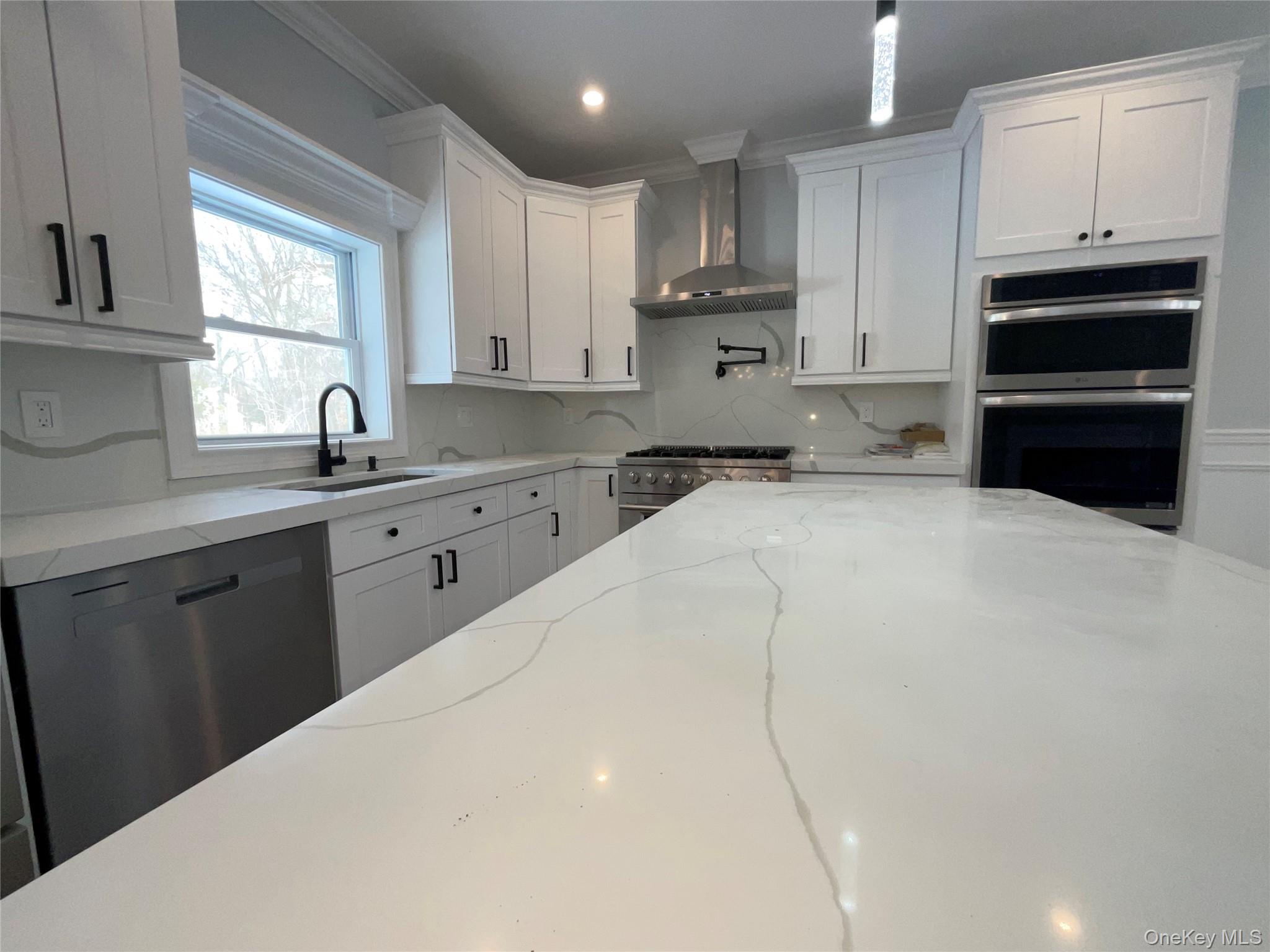 89 B Mount Sinai-Coram Road Coram, NY 11727 - Photo 8 of 23 a kitchen with a sink a stove and cabinets