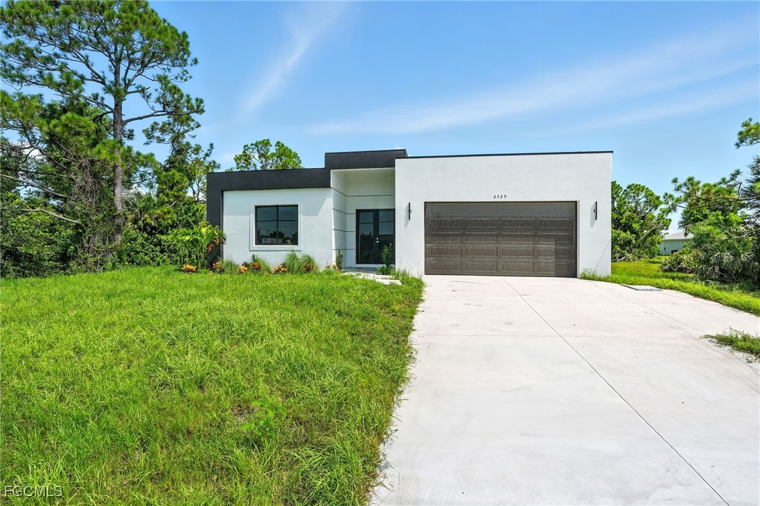 2725 Embers Parkway West Cape Coral, FL 33993 - Photo 1 of 32 a front view of house with yard and green space