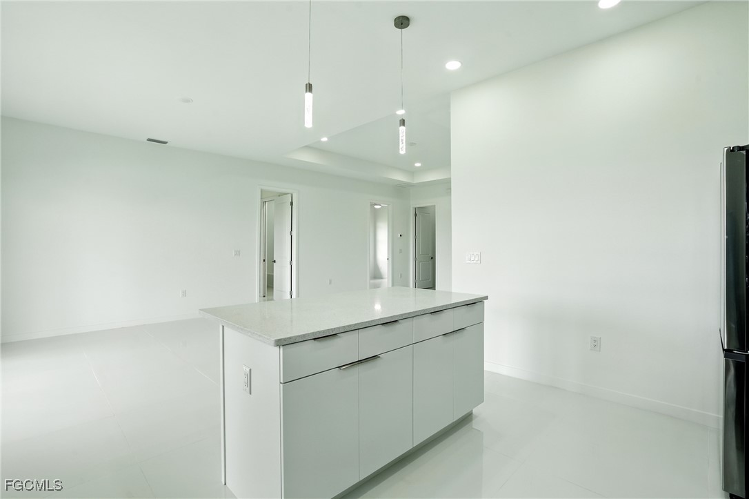 2725 Embers Parkway West Cape Coral, FL 33993 - Photo 13 of 32 a view of a sink and a refrigerator in a room