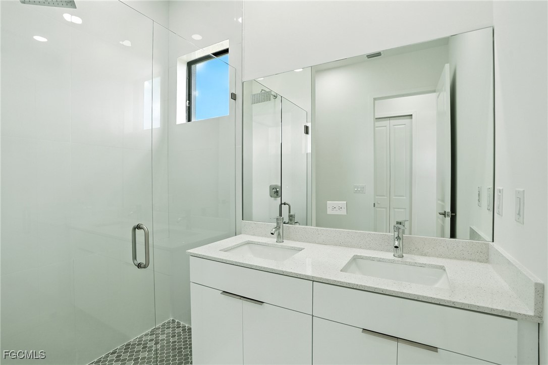 2725 Embers Parkway West Cape Coral, FL 33993 - Photo 18 of 32 a bathroom with a sink and a mirror