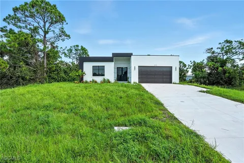 a front view of a house with yard and green space