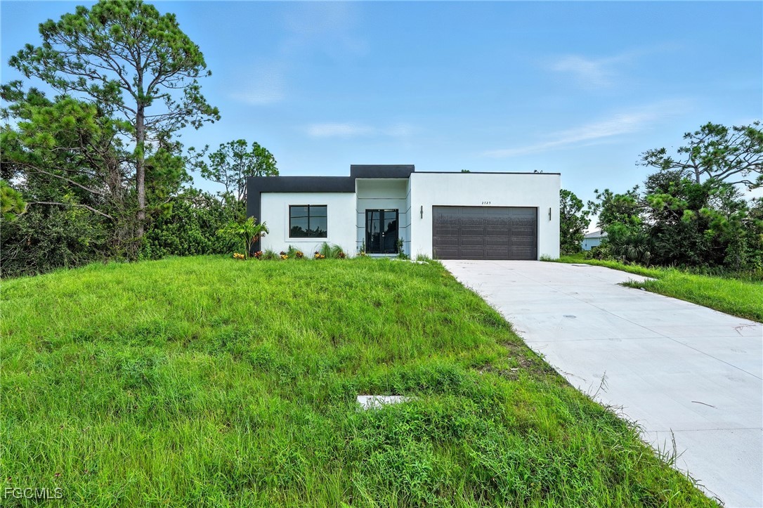 2725 Embers Parkway West Cape Coral, FL 33993 - Photo 2 of 32 a front view of a house with yard and green space