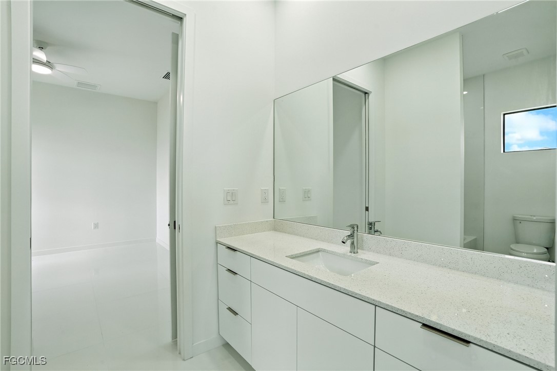 2725 Embers Parkway West Cape Coral, FL 33993 - Photo 24 of 32 a bathroom with a sink and a mirror