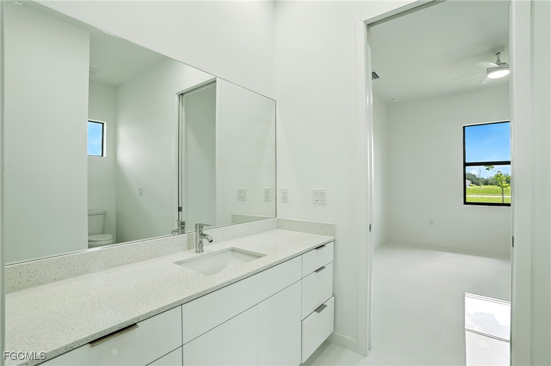 2725 Embers Parkway West Cape Coral, FL 33993 - Photo 26 of 32 a bathroom with a sink and a mirror