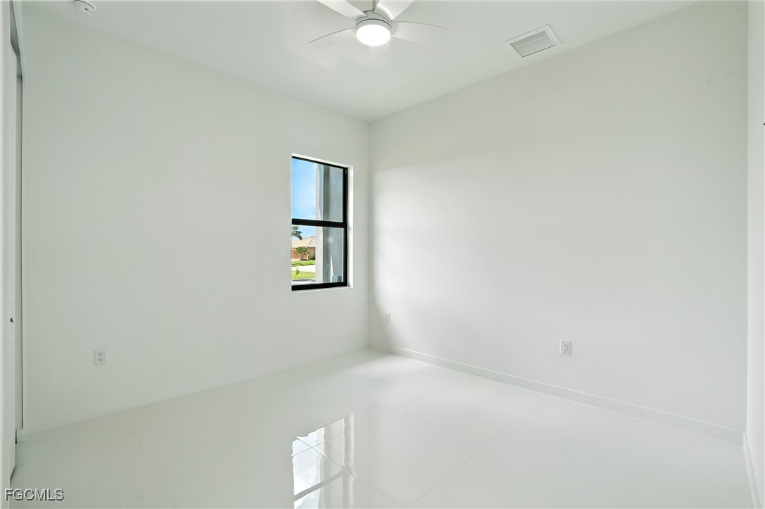 2725 Embers Parkway West Cape Coral, FL 33993 - Photo 27 of 32 an empty room with a window and a ceiling fan