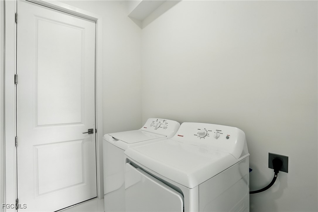2725 Embers Parkway West Cape Coral, FL 33993 - Photo 29 of 32 a utility room with dryer and washer