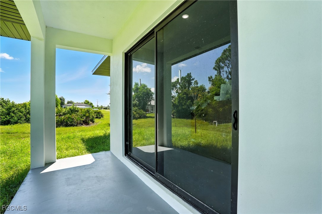 2725 Embers Parkway West Cape Coral, FL 33993 - Photo 31 of 32 a view of a glass door and a yard