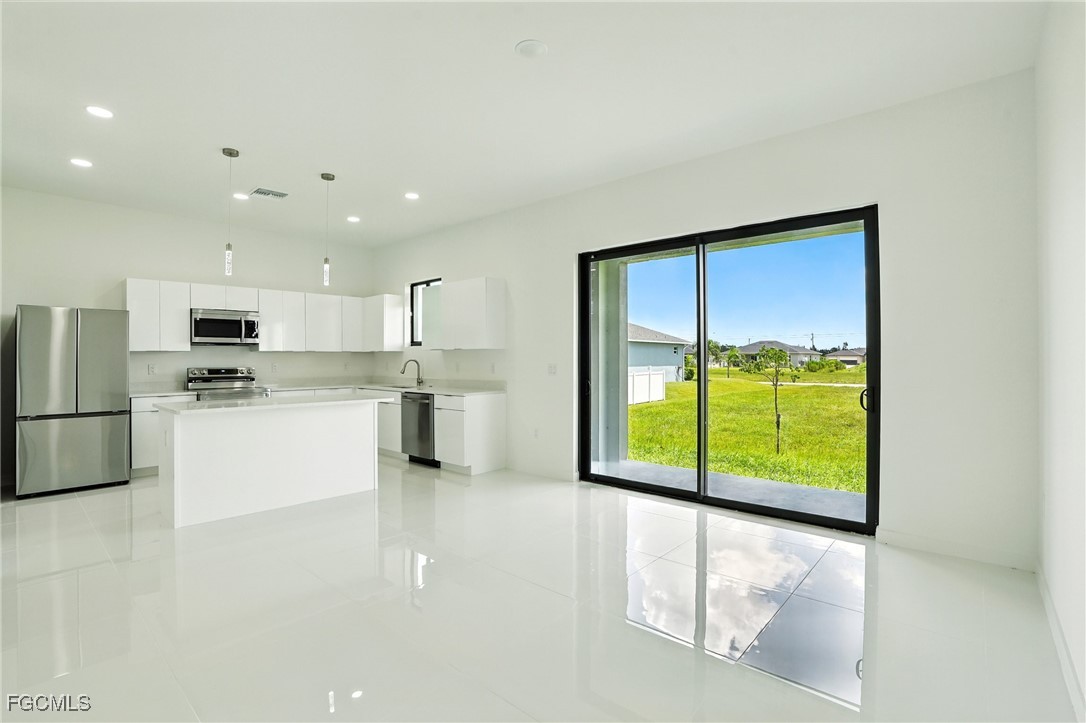 2725 Embers Parkway West Cape Coral, FL 33993 - Photo 6 of 32 a view of kitchen with stainless steel appliances granite countertop a refrigerator a stove and a sink