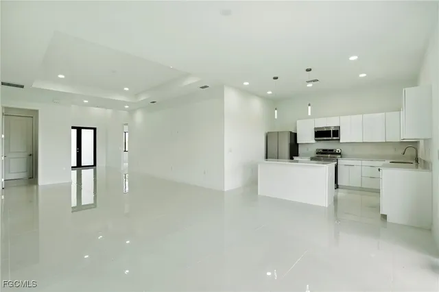 an empty room with window and cabinet