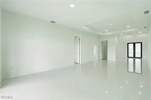 a kitchen with stainless steel appliances a stove top oven a refrigerator a sink a microwave a counter top and white cabinets