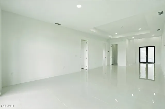 a kitchen with stainless steel appliances a stove top oven a refrigerator a sink a microwave a counter top and white cabinets