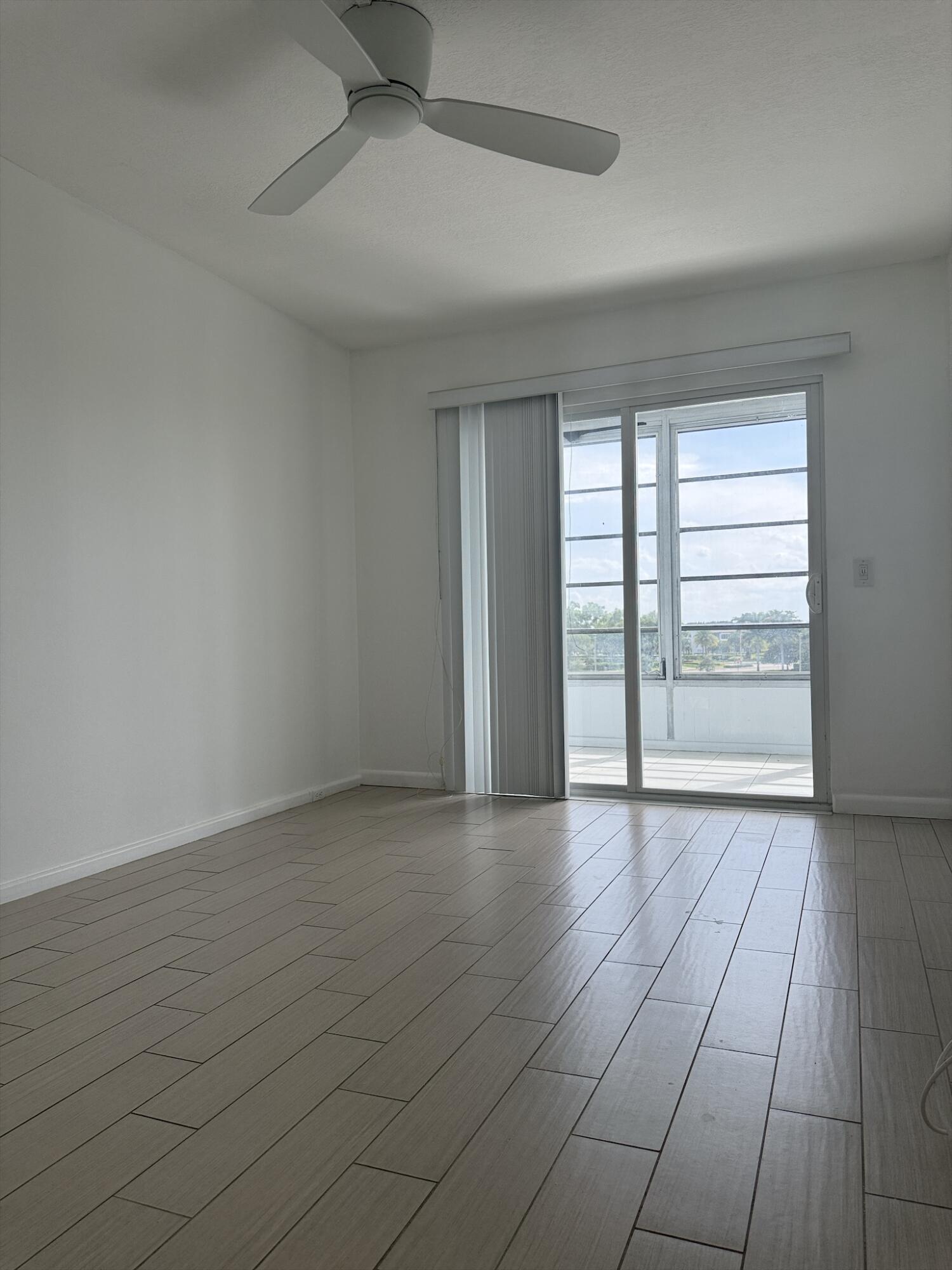 4085 Cornwall East Boca Raton, FL 33434 - Photo 12 of 15 wooden floor in an empty room with a window