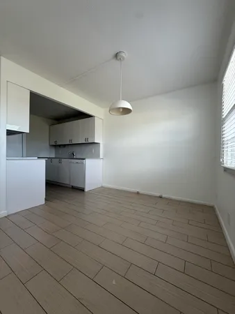 a kitchen with stainless steel appliances granite countertop a refrigerator and a stove