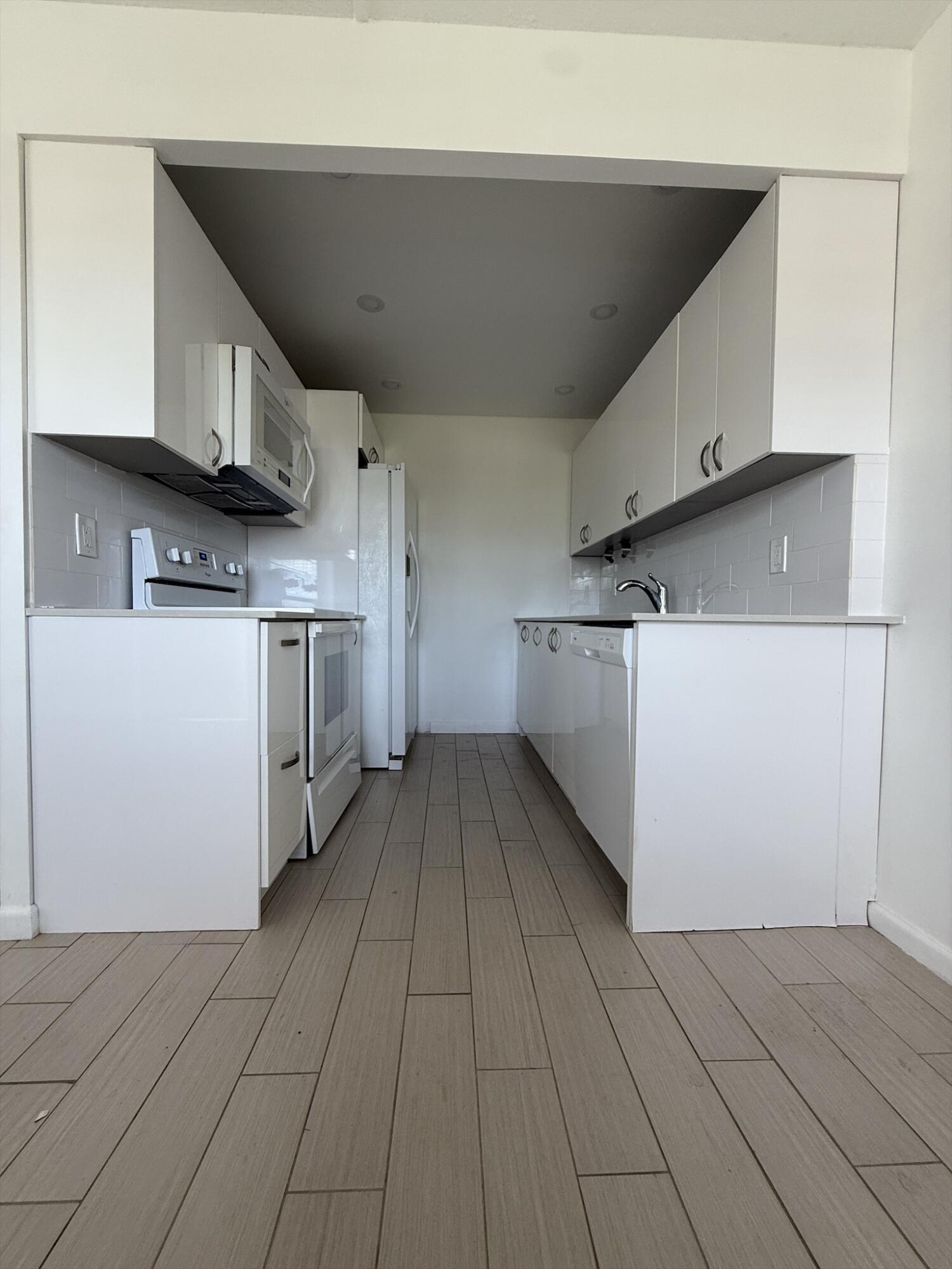 4085 Cornwall East Boca Raton, FL 33434 - Photo 5 of 15 a kitchen with stainless steel appliances granite countertop a refrigerator and a stove