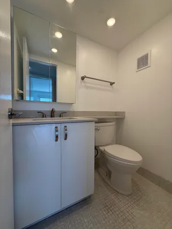 a bathroom with a shower a toilet and sink