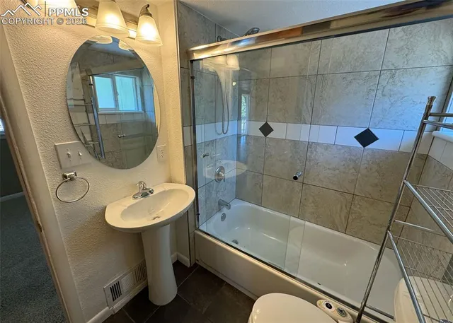 a bathroom with a sink and mirror